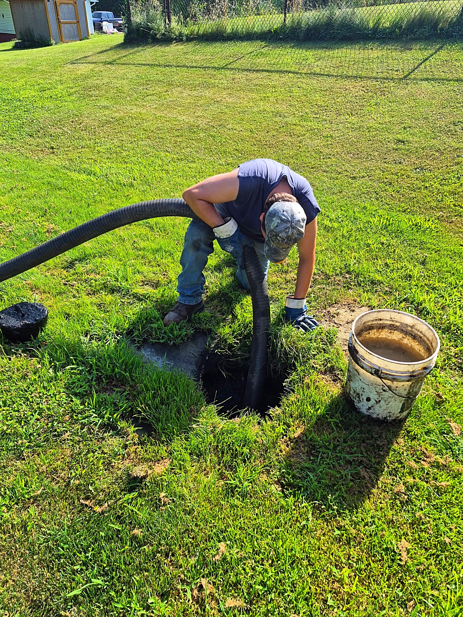 T.E. Griffith technician pumping a residential septic tank.